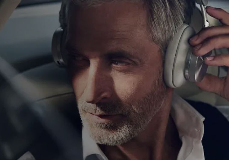 custom-website-design-company-bang-olufsen-background-image closeup of a man listening to music