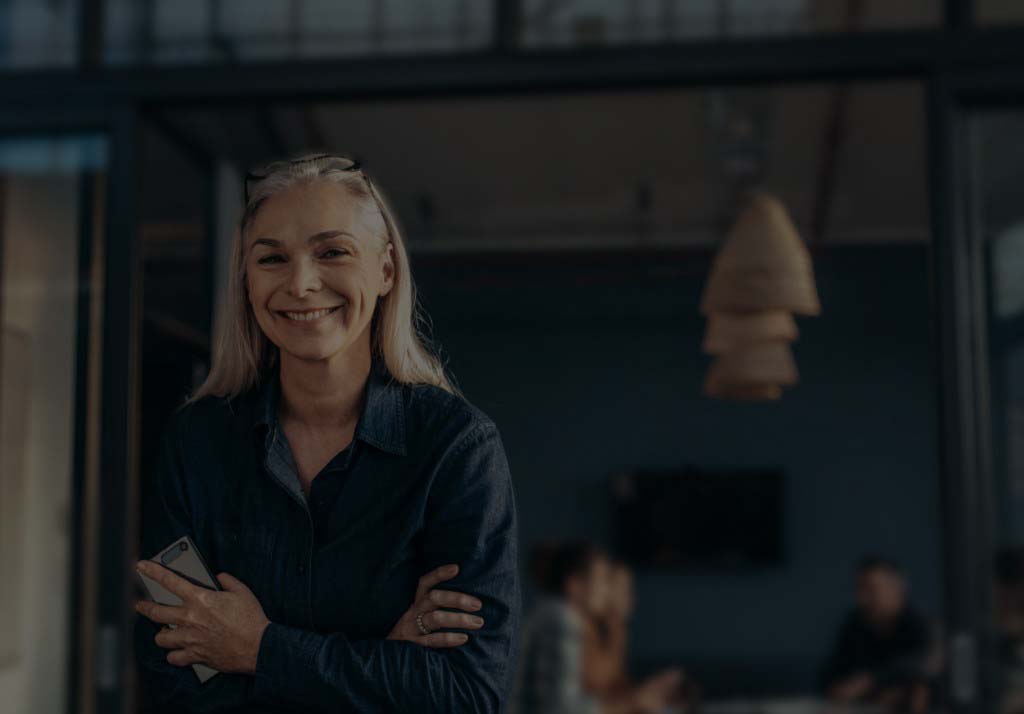 A smiling woman in a background image for FieldEdge